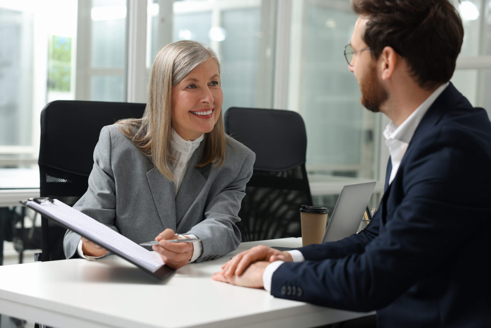 Two professionals engaged in a positive business discussion in an office.